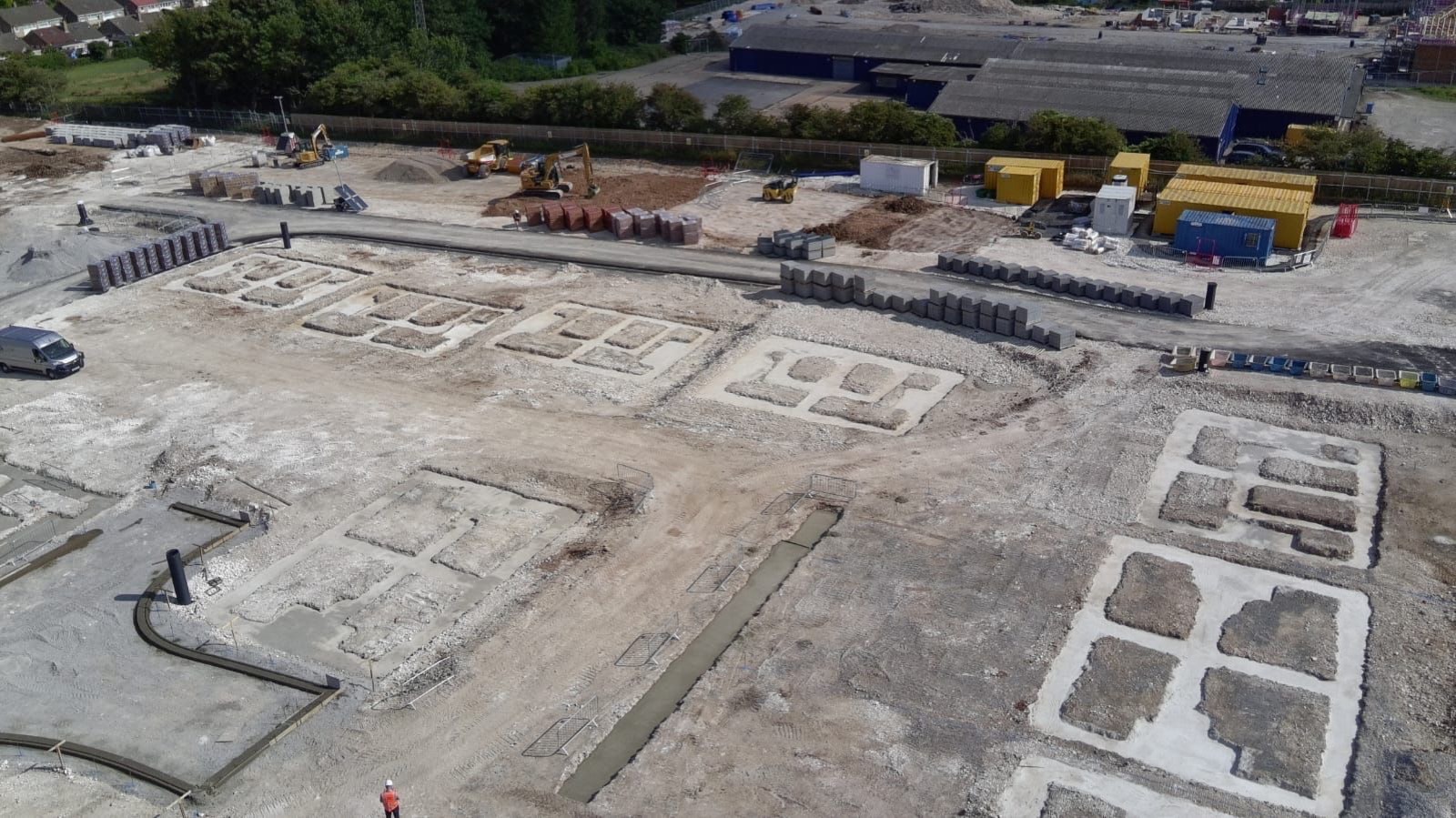Aerial view of an Athena housing development site with foundations laid out