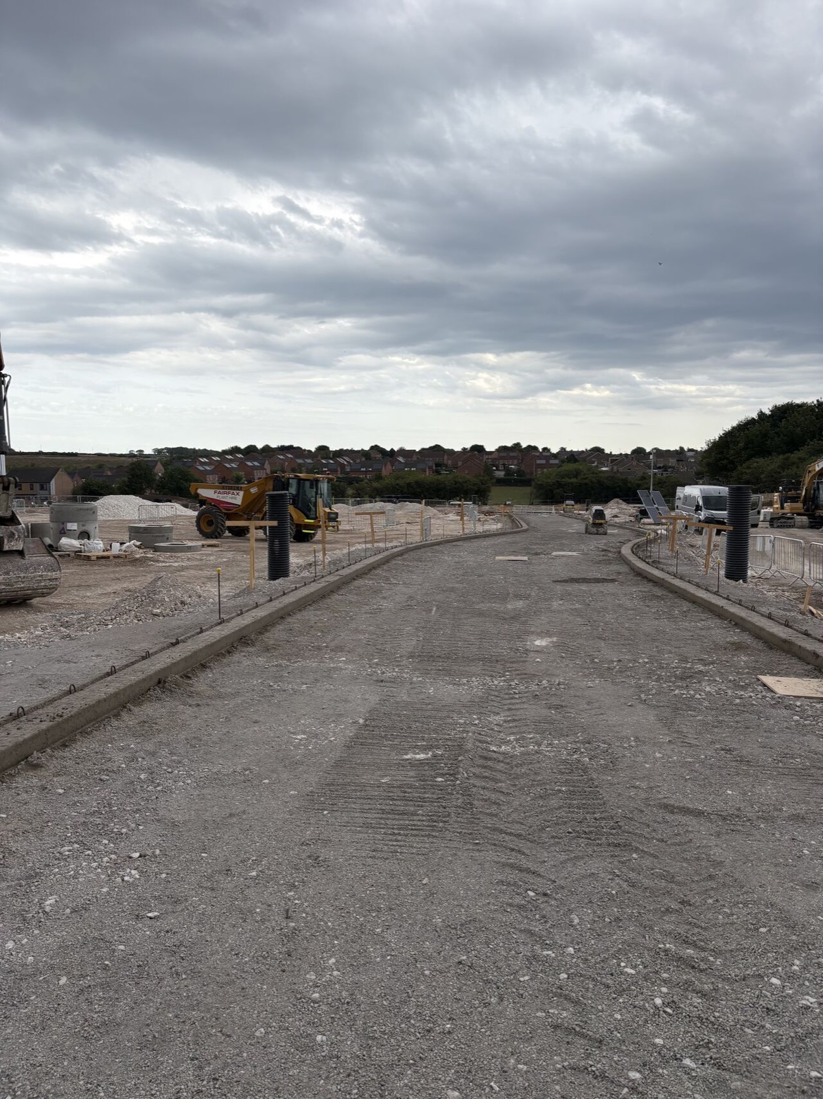 New kerbed estate road built by Athena with housing behind