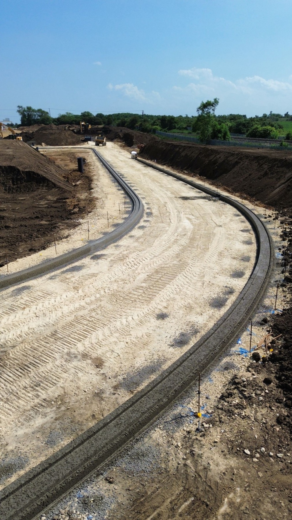 Sweeping kerbed road built by Athena